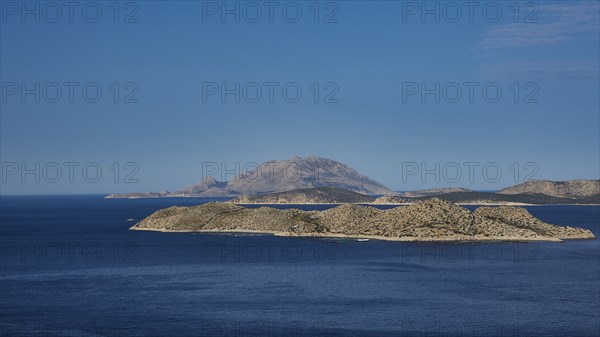 View of an island in the blue sea, surrounded by clear skies and wide expanses of water, Makri