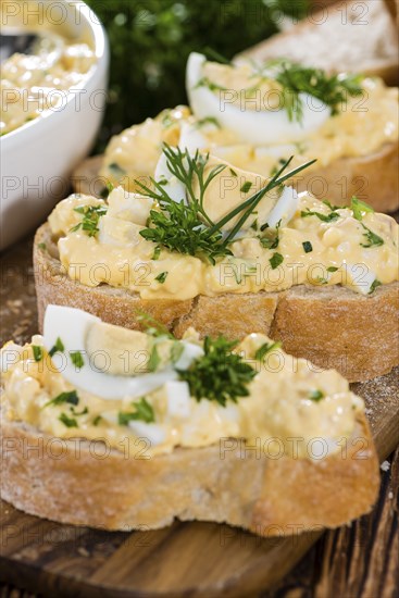 Piece of Bread with fresh homemade Egg Salad (close-up shot)