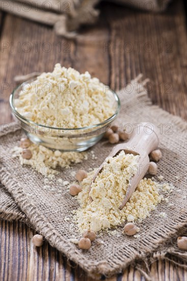 Heap of Chick Pea flour on an old wooden table