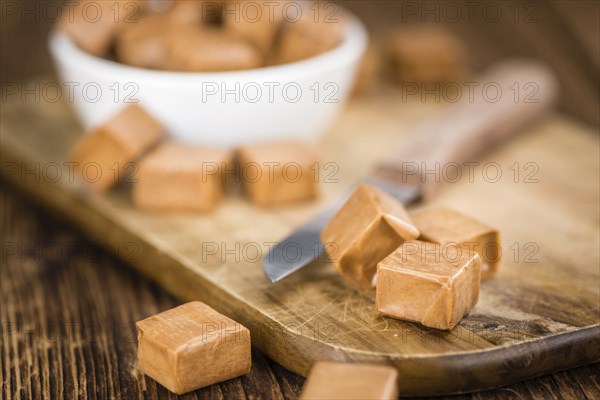 Caramel on a vintage background as detailed close-up shot (selective focus)