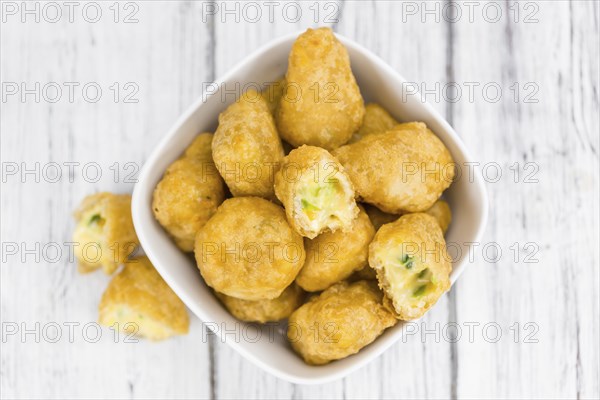 Chili Cheese Nuggets on a vintage background as detailed close-up shot (selective focus)