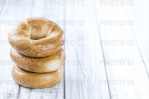 Plain Bagel (selective focus) on vintage background (close-up shot)