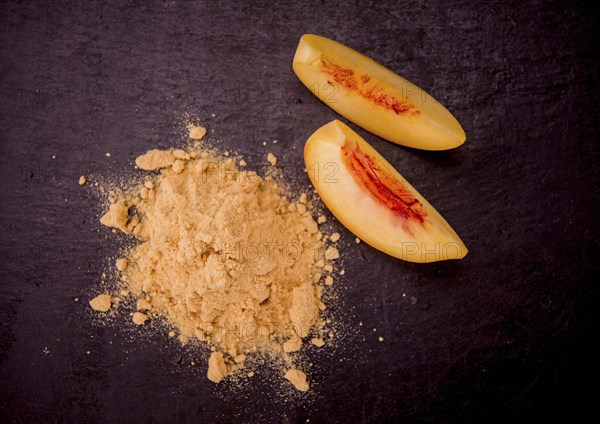 Peach powder on a vintage slate slab as detailed close-up shot, selective focus