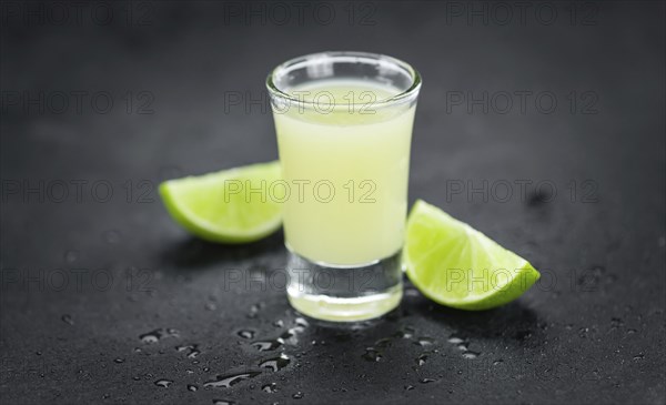 Portion of Fresh Lime Juice on a rustic slate slab (selective focus, close-up shot)
