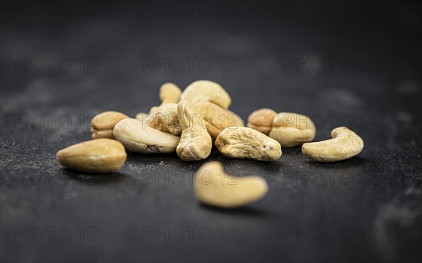Some roasted Cashew Nuts as detailed close up shot (selective focus)
