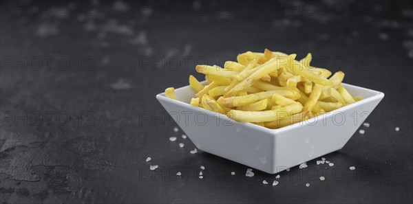 Portion of fresh made crispy French Fries (selective focus, close-up shot)