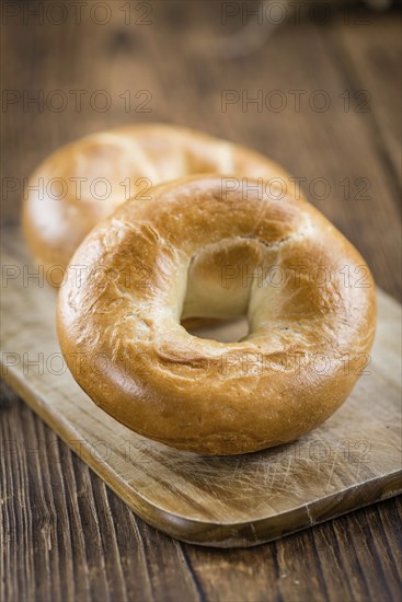 Fresh baked Bagels on a wooden table (selective focus, close-up shot)