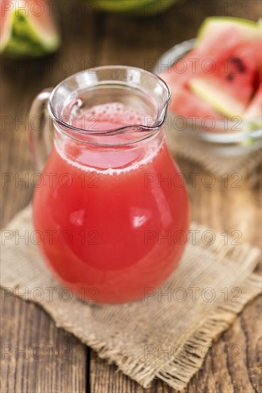 Watermelon Smoothie on rustic wooden background (close-up shot)