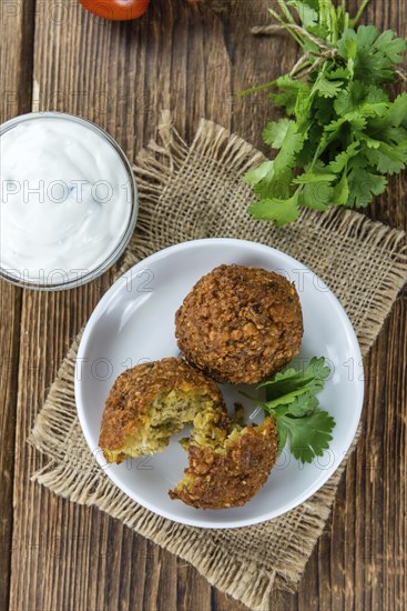 Homemade Falafel (close-up shot, selective focus) on wooden background