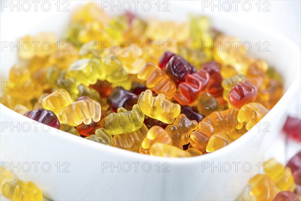 Wooden table with Gummy Bears (close-up shot, selective focus)