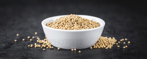 Portion of fresh made Mustard Seeds (close-up shot, selective focus)