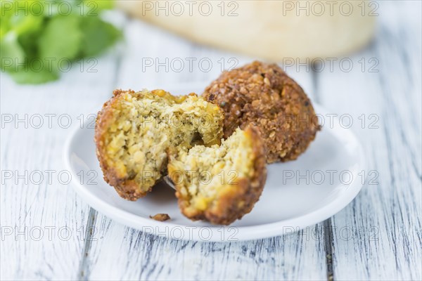 Homemade Falafel (close-up shot, selective focus) on wooden background