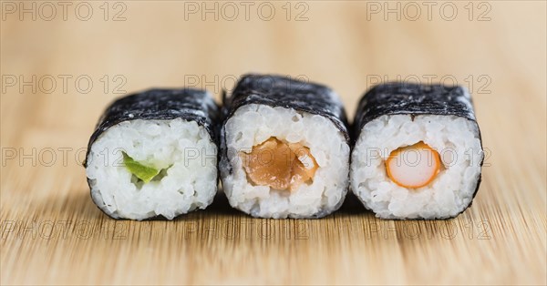 Portion of Sushi on a wooden table (selective focus, close-up shot)