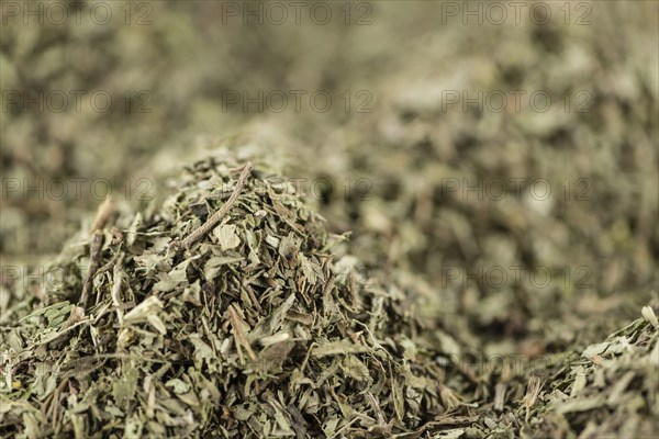 Stevia leaves (dried) for use as background image or as texture (close-up shot, selective focus)