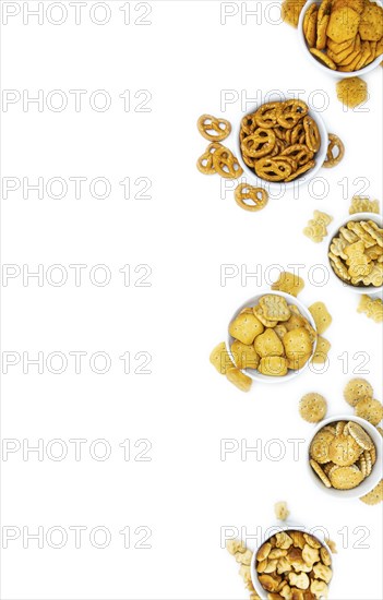 Portion of mixed Snacks isolated on white background (close up shot, selective focus)