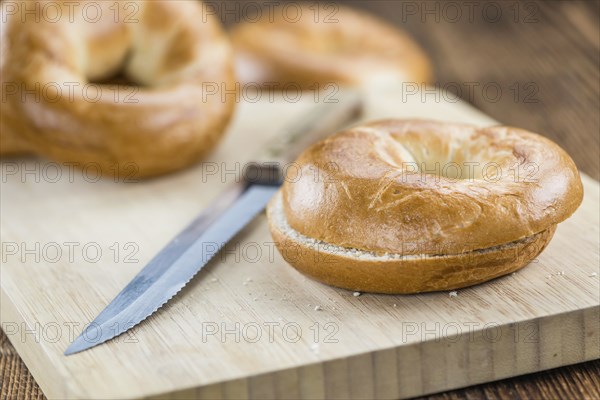 Fresh made plain Bagel (selective focus) on vintage background (close-up shot)