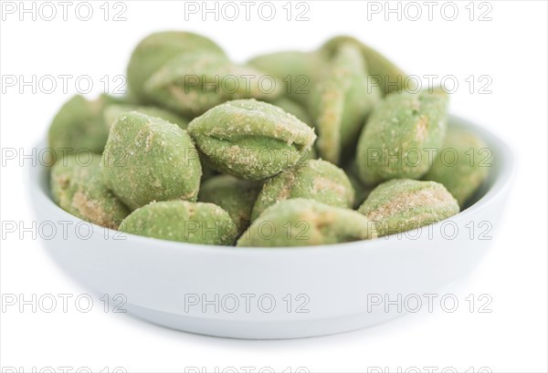 Peanuts (with Wasabi flavor) isolated on white background (selective focus, close-up shot)