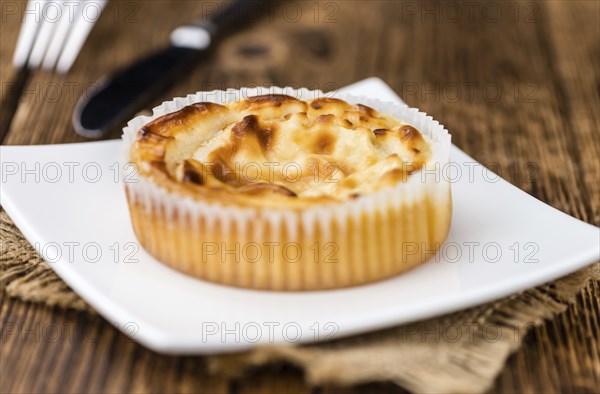Fresh made Mini Cheesecake on an old and rustic wooden table (selective focus, close-up shot)