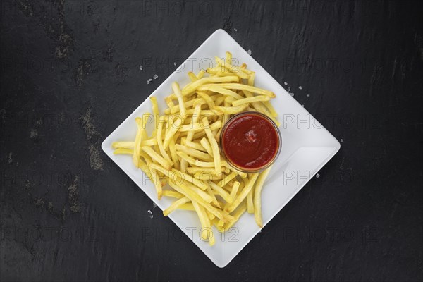 Portion of fresh made French Fries (close-up shot, selective focus)