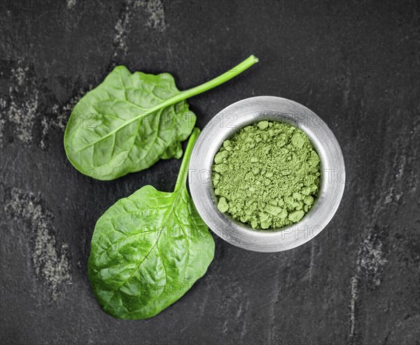 Homemade green spinach powder (close up shot, selective focus)