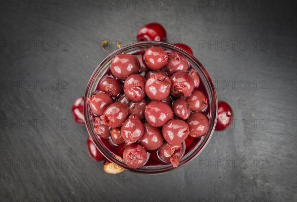 Preserved Cherries on a vintage slate slab as detailed close-up shot, selective focus