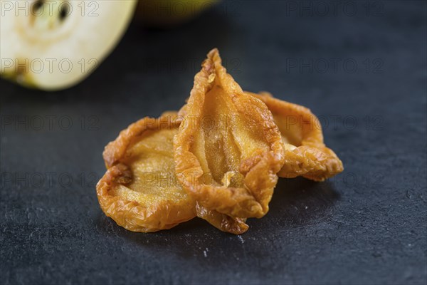 Slate slab with dried Pears (close-up shot, selective focus)