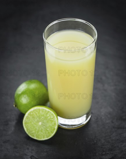 Some Fresh Lime Juice on a slate slab (close-up shot, selective focus)