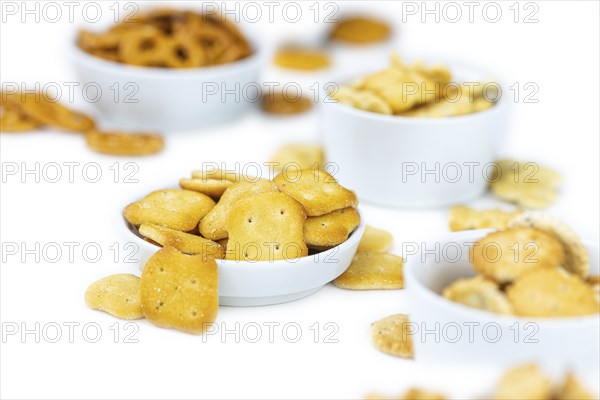 Portion of mixed Snacks isolated on white background (close up shot, selective focus)