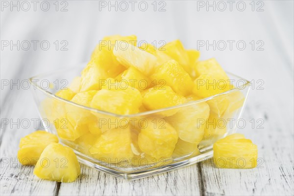 Sliced Pineapple on rustic wooden background as close-up shot