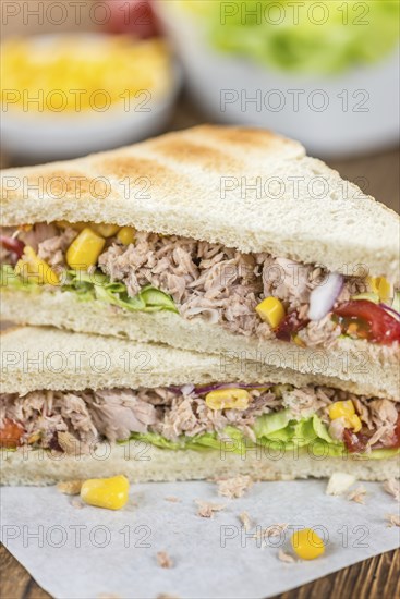 Homemade Tuna Sandwich (selective focus, close-up shot) on vintage wooden background