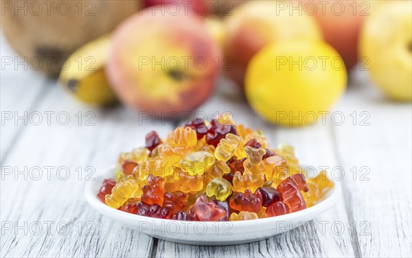 Wooden table with Gummy Bears (close-up shot, selective focus)