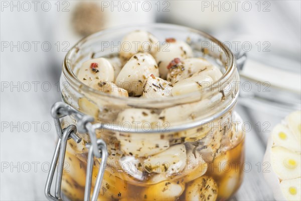 Portion of fresh Preserved Garlic (close-up shot, selective focus)