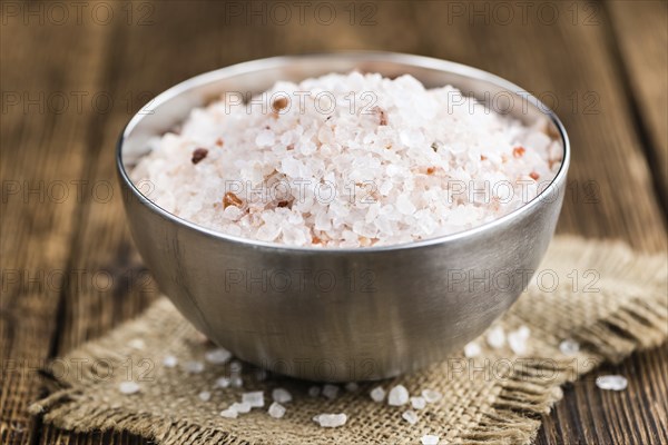 Himalayan Salt as high detailed close-up shot on a vintage wooden table (selective focus)