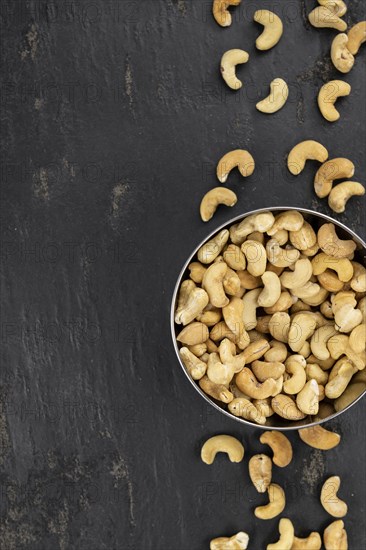 Portion of roasted Cashew Nuts (close up shot, selective focus)