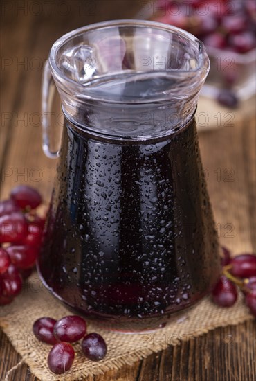 Fresh Red Grape Juice as detailed close-up shot (selective focus)