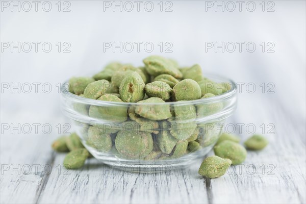 Wasabi Peanuts on a vintage background as detailed close-up shot (selective focus)