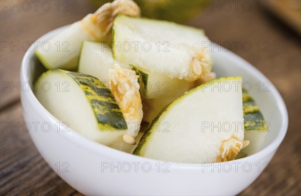 Futuro Melons on an old wooden table as detailed close-up shot (selective focus)