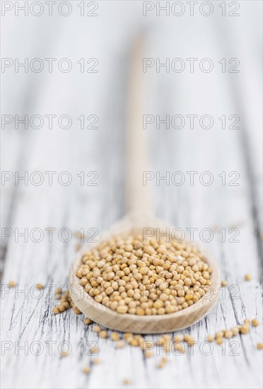 Mustard Seeds on a vintage background as detailed close-up shot (selective focus)