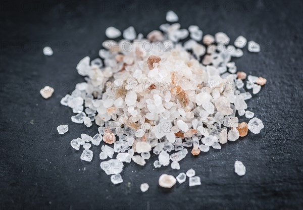 Portion of Himalayan Salt on a rustic slate slab (selective focus, close-up shot)