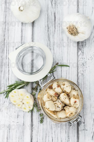 Fresh made Garlic (preserved) on a vintage background (close-up shot)