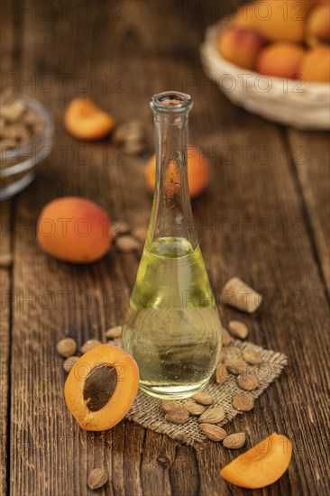 Portion of Apricot Oil with some fresh fruits as detailed close up shot (selective focus)