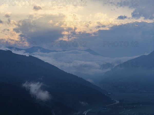 Evening clouds and fog over the Liesingtal, in the valley the village of Traboch, Schoberpass