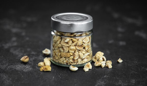 Freshly chopped Hazelnuts as detailed close up shot (selective focus)