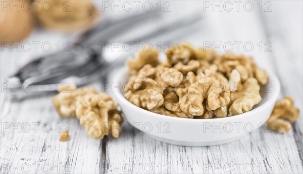Walnut kernels on a vintage background as detailed close-up shot (selective focus)