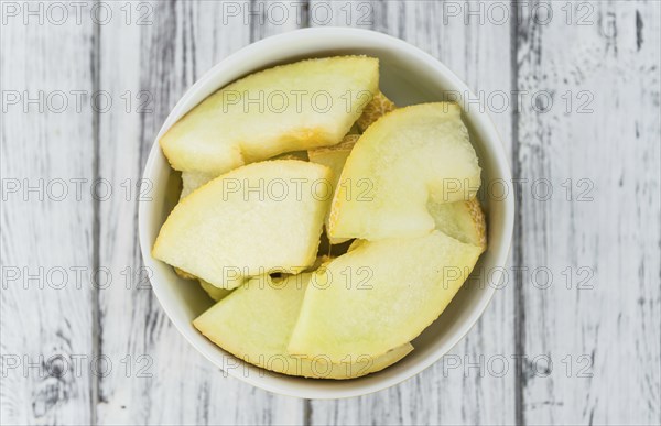 Honeydew Melon on a vintage background as detailed close-up shot (selective focus)