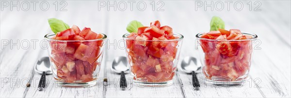 Homemade Cutted Tomatoes on vintage background (selective focus, close-up shot)