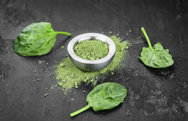 Homemade green spinach powder (close up shot, selective focus)