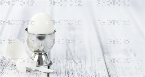 Some boiled Eggs (close-up shot, selective focus) on an old wooden table