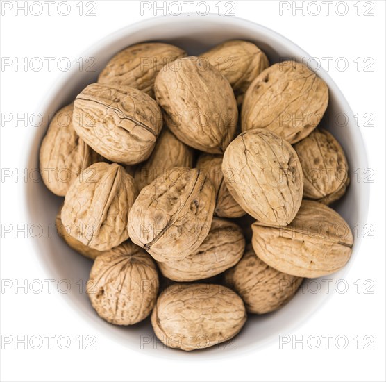 Portion of Walnuts (as close-up shot) isolated on white background