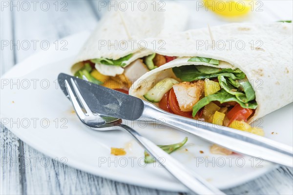 Fresh made Chicken Wraps on an vintage background (selective focus)